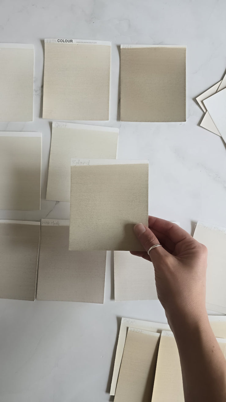 Professional compares close shades of neutrals and white limewash paint with the aid of a full range box set of colour cards | © Charlotte Cropper