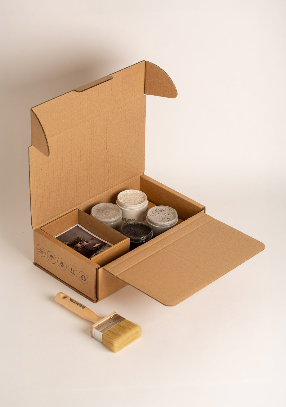 Modern Minimalist Garden Pot Paint Collection box with four 250ml limewash paint pots in cool monochrome tones, a natural bristle brush and inspiration card. | © Bauwerk Colour