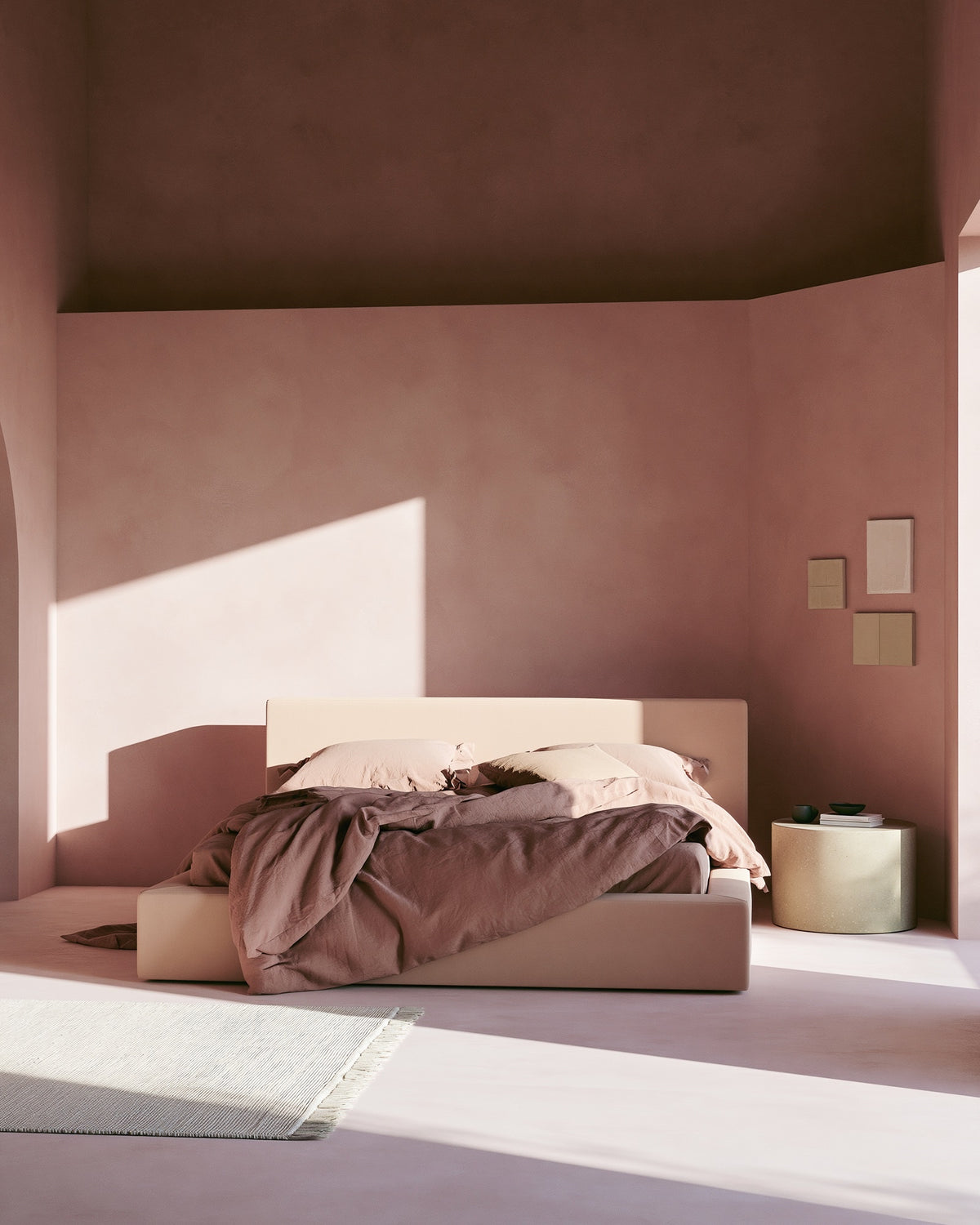 An interior bedroom wall finished in Bauwerk Colour Malibu limewash, showing it's pink tone and texture. | © Bauwerk Imagined