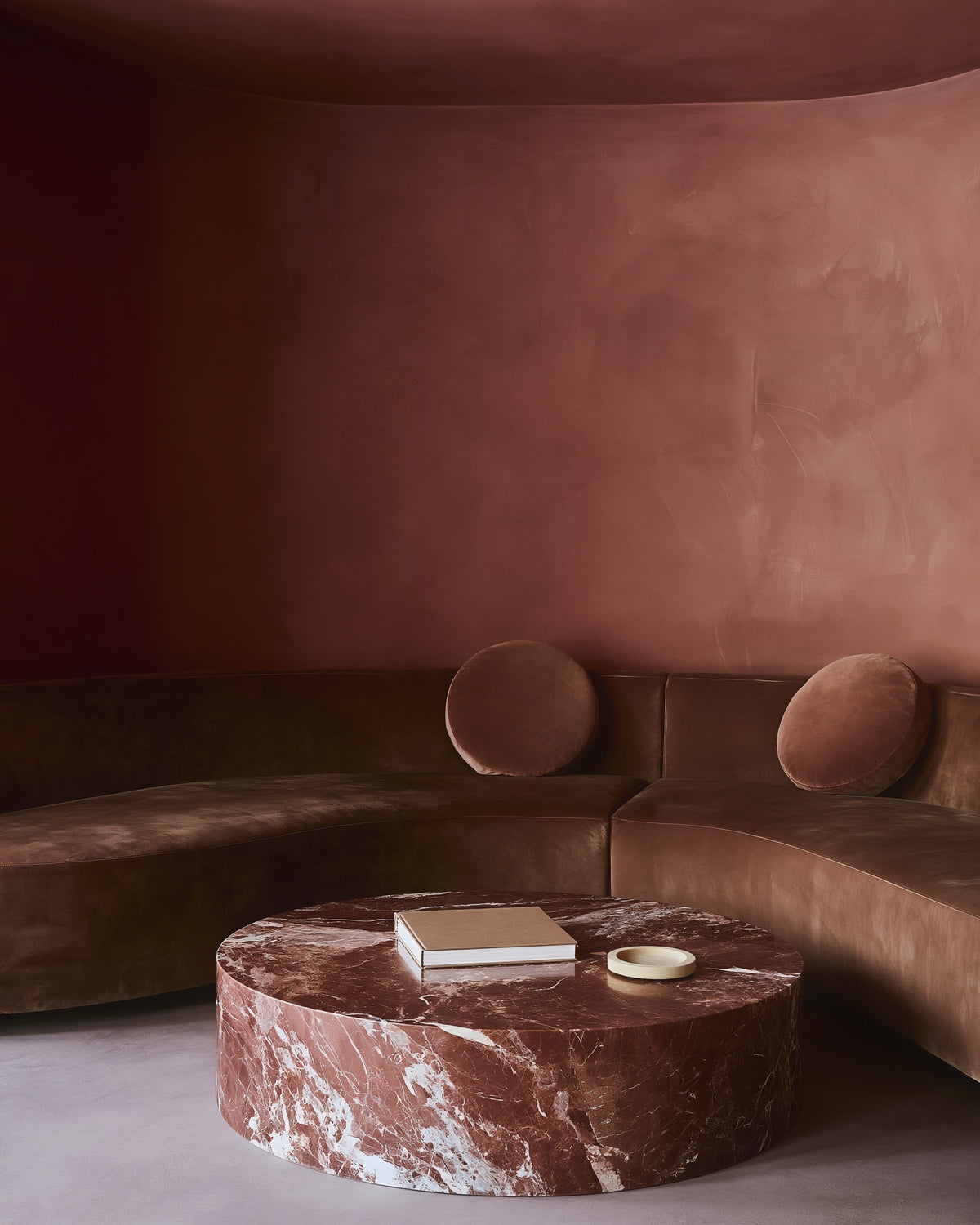 A waiting room finished in Bauwerk Colour Pheasant limewash, showing it's reddish pink tone. | © Bauwerk Imagined